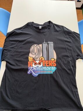 Hooters 9-11  Black Short Sleeve Tee with Orange, Turquoise & Purple Graphic